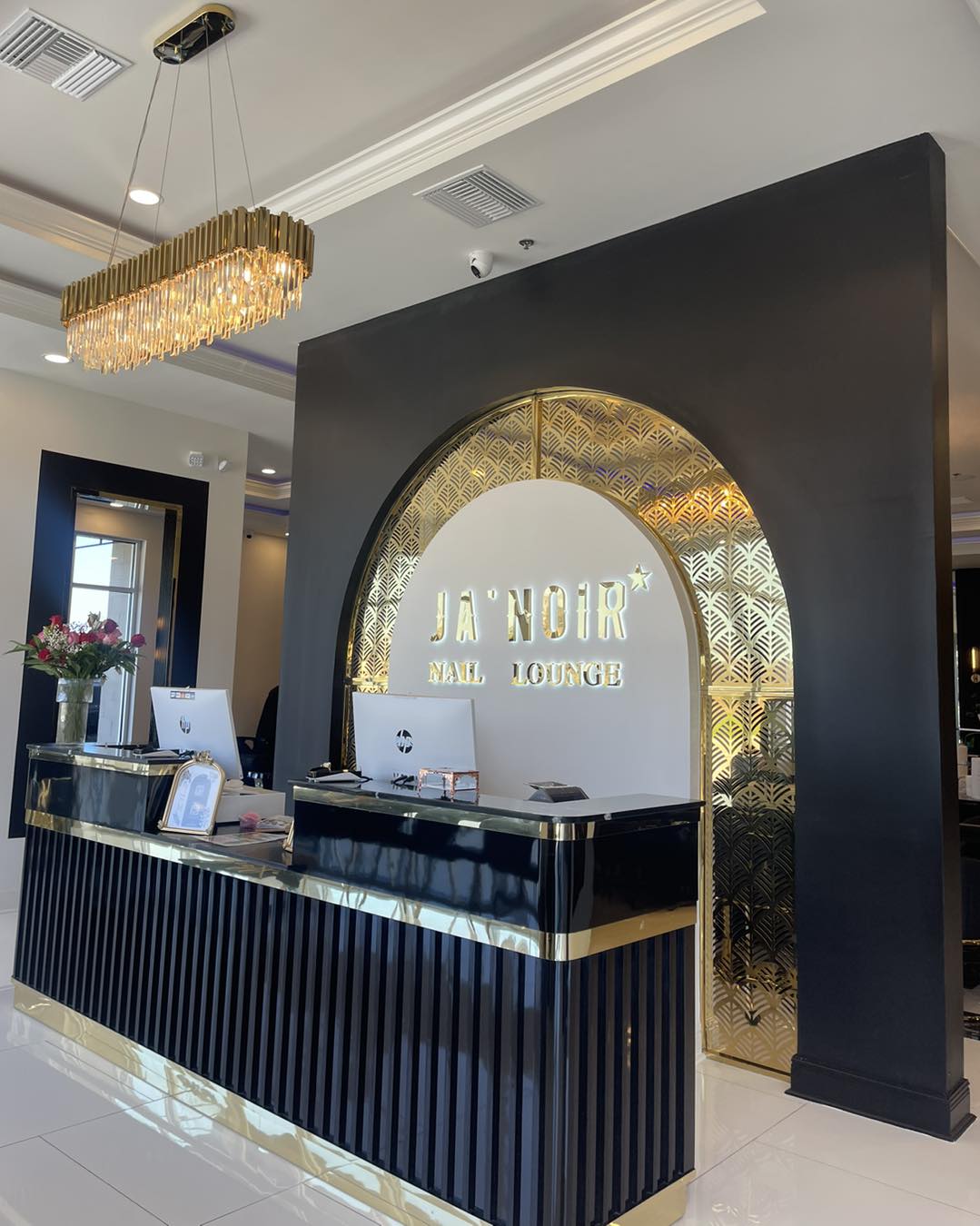 Ja'noir Nail Lounge — reception desk with brand signage