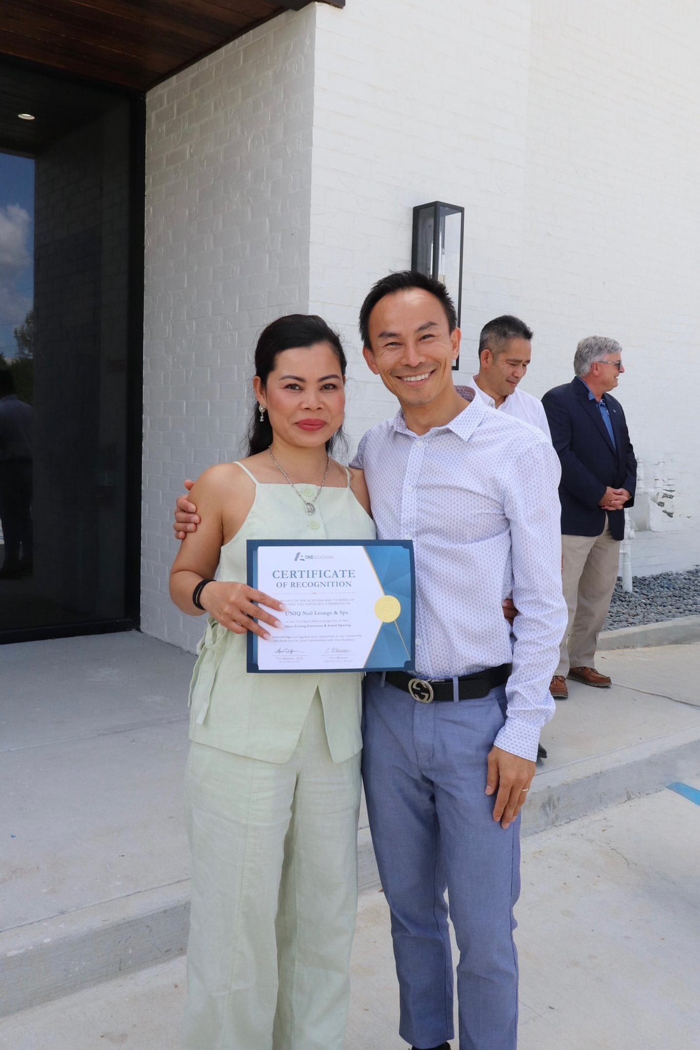 Thang Duong receiving Certificate of Recognition from One Acadiana at UNIQ Nail Lounge grand opening