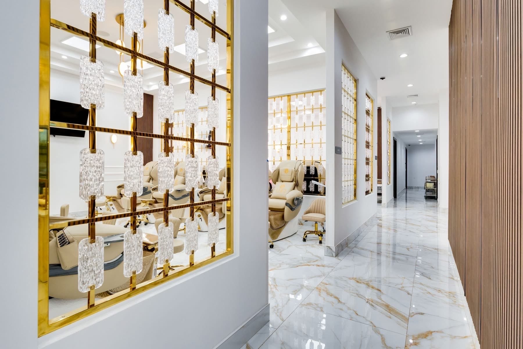 UNIQ Nail Lounge & Spa hallway with gold grid wall and crystal pendant detailing